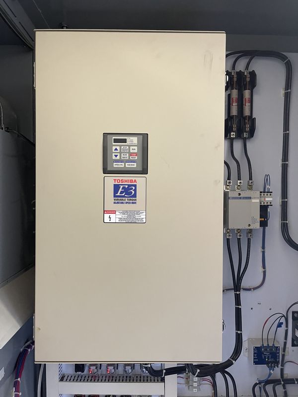 Beige Toshiba E3 variable torque drive inside the cabinet with fuses and a contactor beside it